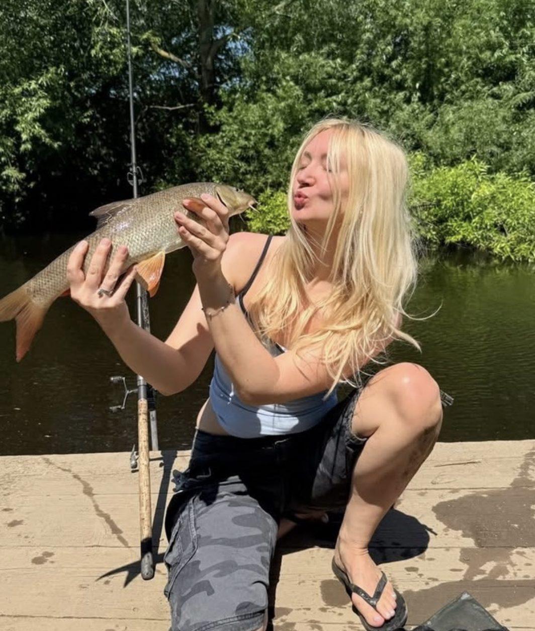 A guest giving a barbel a kiss at the pegs